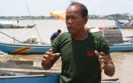Saman Kosim, 60, talks about the damage to his boat after being hit by a sand barge, in Phnom Penh on July 12, 2021. (Michael Dickison/VOD)