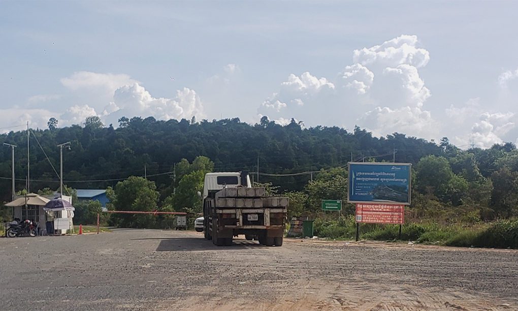 A truck loaded with cement beams stops in front of a checkpoint within the Union Development Group concessions in Koh Kong's Kiri Sakor district on June 28, 2021. (Danielle Keeton-Olsen/VOD)