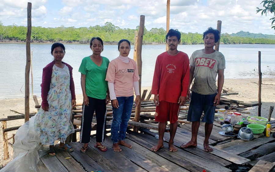 Meah Ream, 58, second from left, stands with four members of her family on the platform left of their house after Union Development Group guards allegedly destroyed it in late June, in Koh Kong's Kiri Sakor district on June 28, 2021. (Danielle Keeton-Olsen/VOD)
