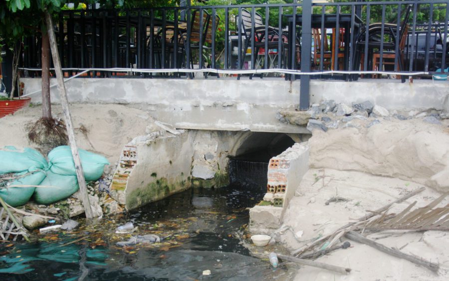 Wastewater is discharged from under a cafe into the river in Kampot city, on August 25, 2021. (Michael Dickison/VOD)