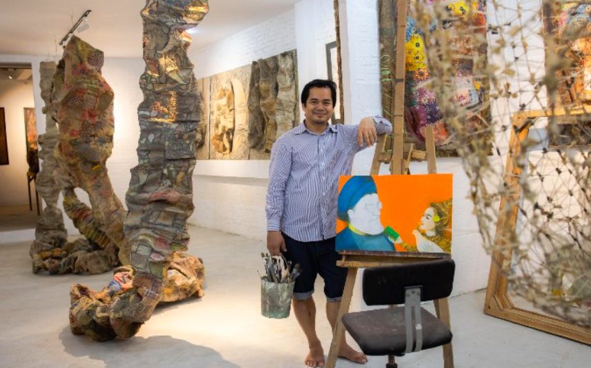 Srey Bandaul, co-founder of Phare Ponleu Selpak, stands among sculptures and paintings in a gallery, in a photo provided by Phare.