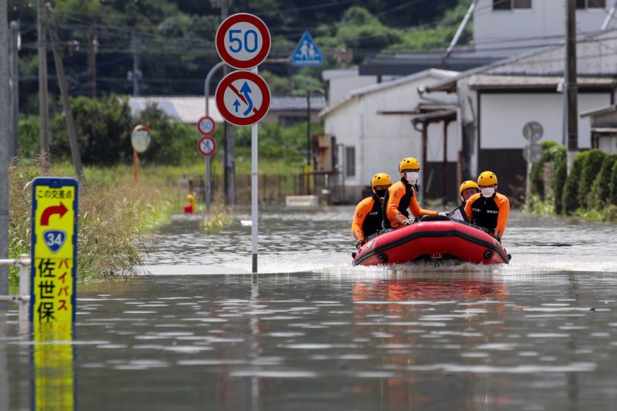 Rescue workers search for survivors at a flooded area in Takeo, Saga Prefecture, western Japan, August 15, 2021. (Reuters)