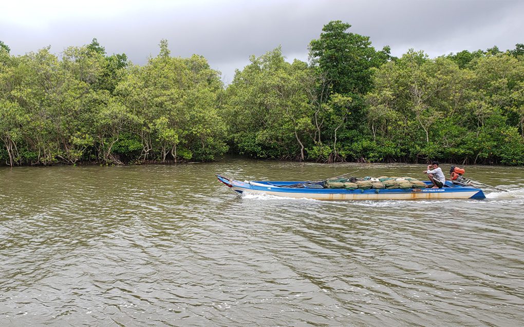 A fisherman drives his boat past the Kampong Samaki community fishery, with members saying he was carrying illegal nets, in Kampot's Kounsat commune on August 25, 2021. (Danielle Keeton-Olsen/VOD)