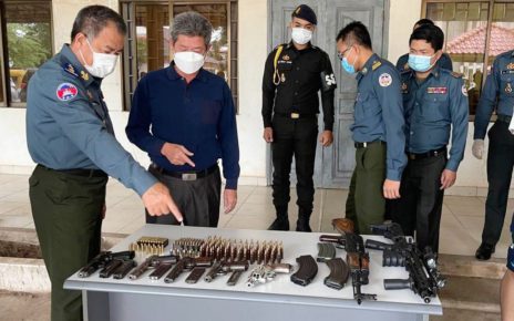 Preah Sihanouk governor Kouch Chamroeun inspects a haul of weapons from an alleged kidnapping, in a photo posted to the Preah Sihanouk military police’s Facebook page.