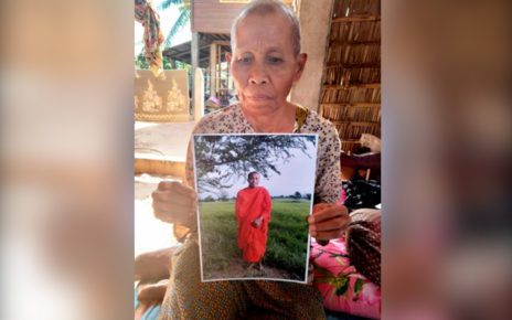 Cham Yem holds a photo of her son, jailed monk activist Koeut Saray. (Soth Ban/VOD)