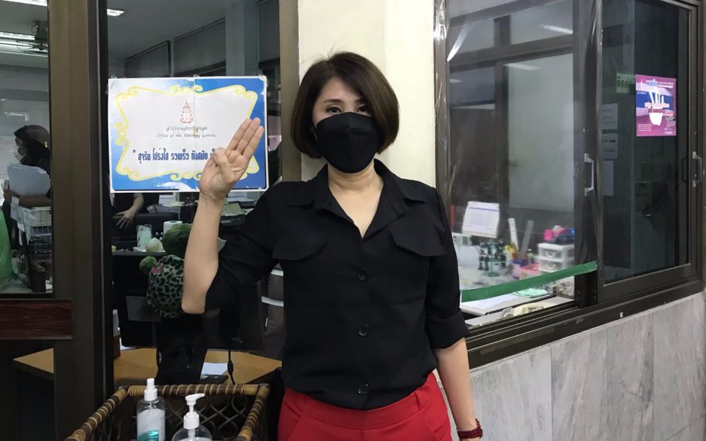 Sitanan Satsaksit poses with the three-finger salute, a protest signal often sported by her brother and exiled Thai activist Wandhalearm before he was allegedly abducted in Phnom Penh, at the Bangkok south district prosecutor's office on October 25, 2021. (Jintamas Saksornchai/VOD)