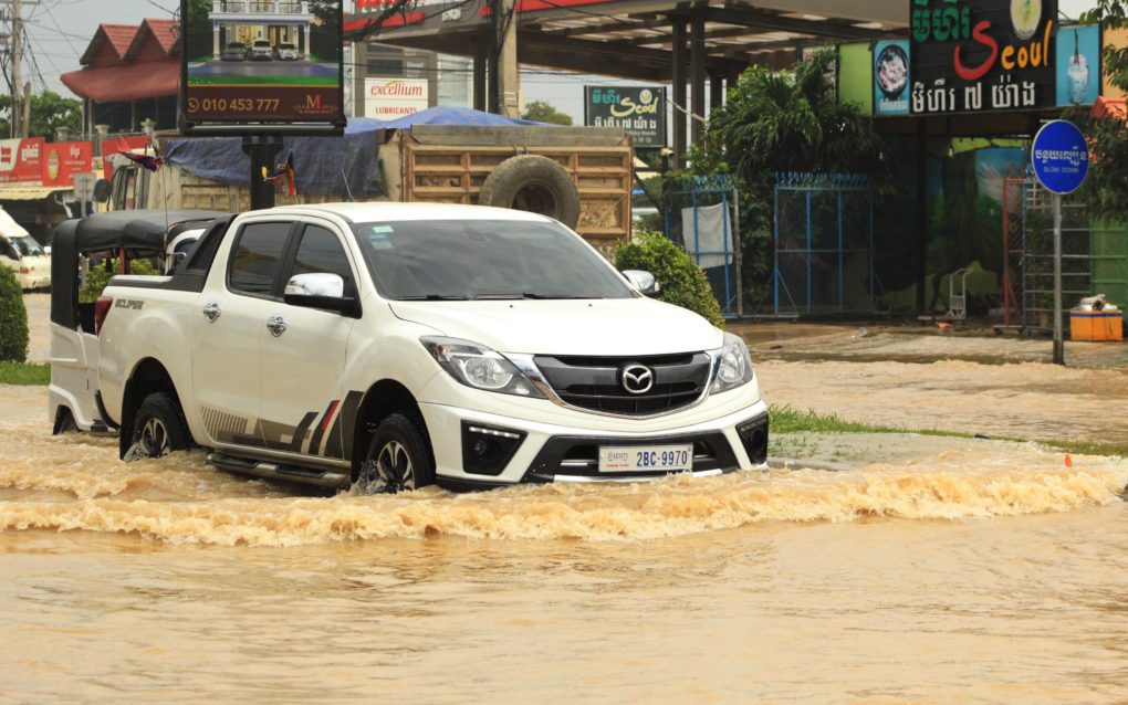 Cars drive through flooded roads in Phnom Penh’s Dangkao district on October 28, 2021. (Andrew Haffner/VOD)