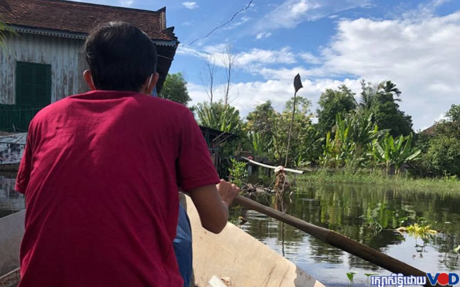 A young resident paddles home after his neighborhood in Chroy Changva has reportedly been flooded for two months. Officials earlier this year had reportedly filled a local canal. Photo taken October 10, 2021.
