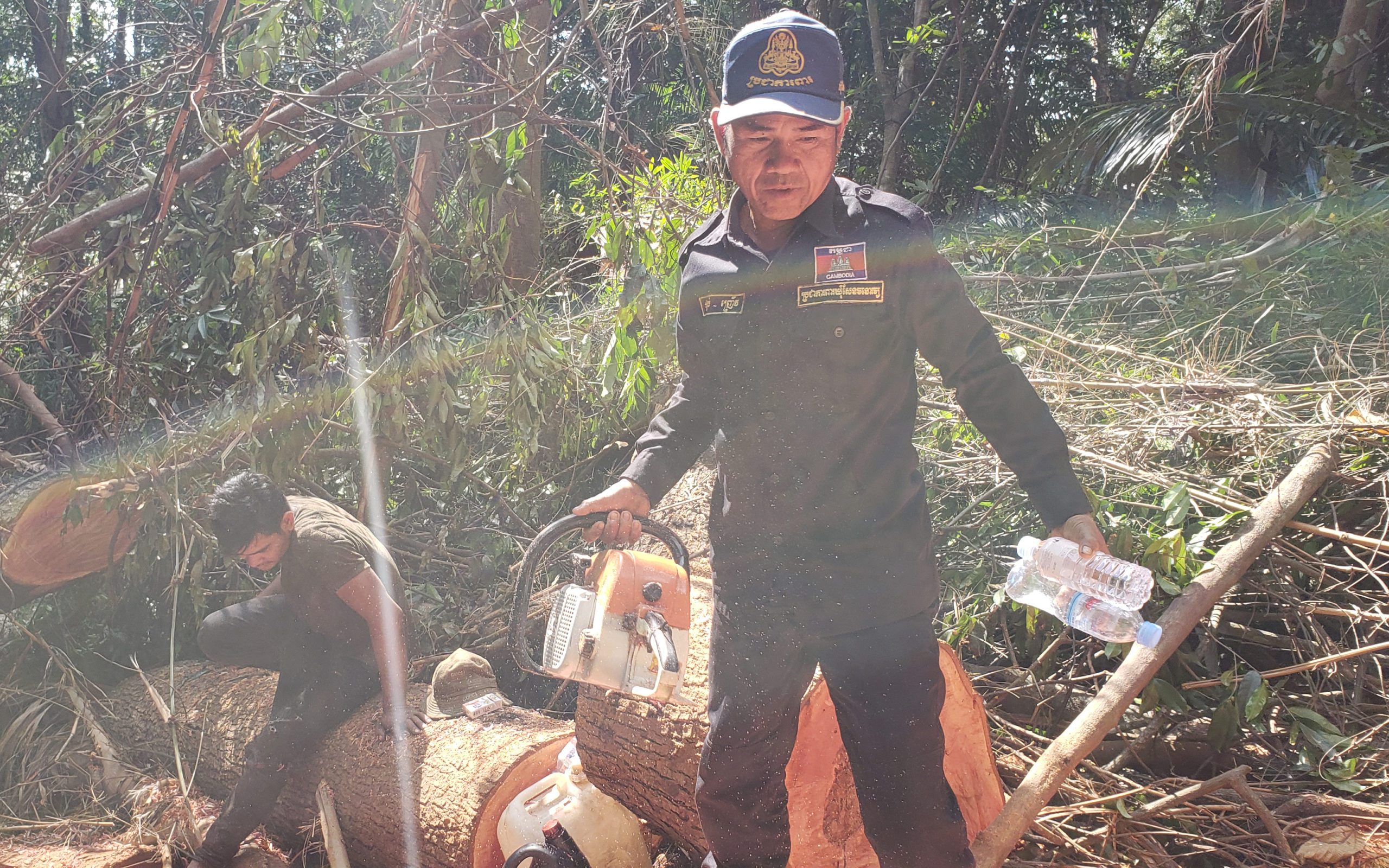 Phsal Nhoeur, 45, an Andoung Kraloeng community patroller, carries a chainsaw away from a man caught cutting a tree in Mondulkiri's Keo Seima Wildlife Sanctuary on February 11, 2021. (Danielle Keeton-Olsen/VOD)
