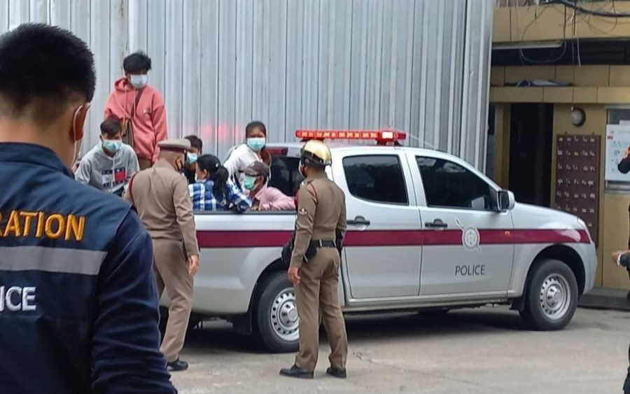 Two police officers detained eight Cambodian migrant workers in the back of a police pickup truck after workers held a petition at the Thai Labor Ministry on October 29, 2021. (Labor Network for People's Rights)