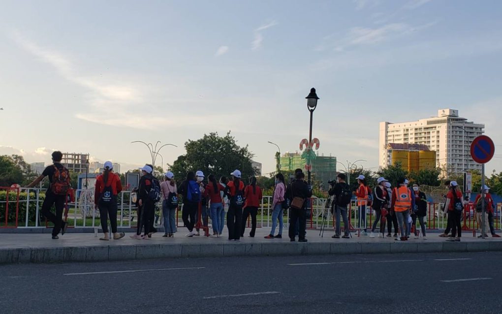 Participants caught outside the barricade wait for the end of the workers' strike in front of Naga 1 on December 18, 2021. (Danielle Keeton-Olsen/VOD)