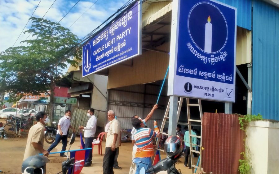 Candlelight Party workers put up party billboards in Kampong Thom province on November 15, 2021. (Candlelight Party's Facebook page)