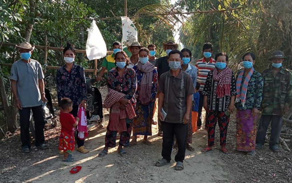 Villagers block a road in Takeo province to prevent trash dumping trucks from reaching a field, in January 2022. (Supplied)