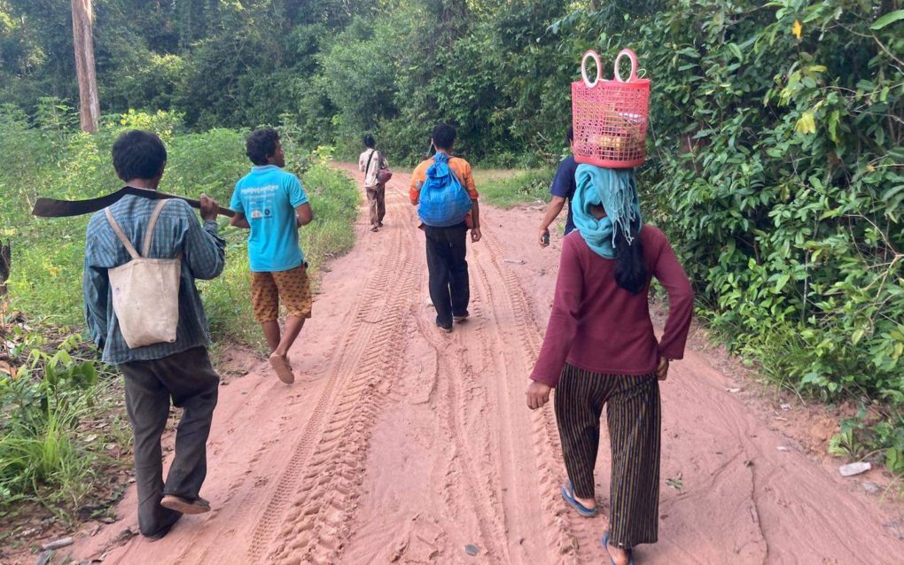 People walk through Preah Vihear province’s Prey Preah Roka Wildlife Sanctuary, in September 2021. (Ananth Baliga/VOD)