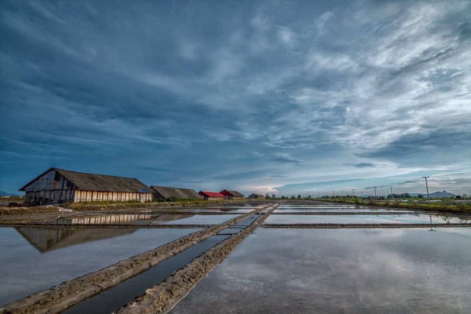 A row of salt storage sheds and flooded salt flats in Kampot province in June 2021. (You Bunchan/VOD)