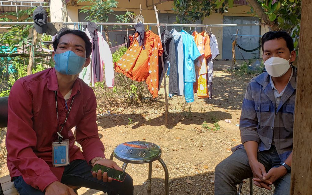 Union organizers Chhoum Phen, left, and Sithar explain working conditions and disputes with supervisors inside Hi-Tech Apparel, a factory within Poipet O'Neang SEZ, on November 26, 2021. (Danielle Keeton-Olsen/VOD)