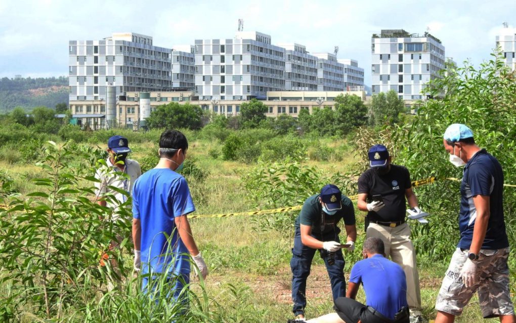 Authorities examine a corpse found near Sihanoukville’s ‘Chinatown’ compound in June 2021. (Courtesy of SNTV Breaking News)