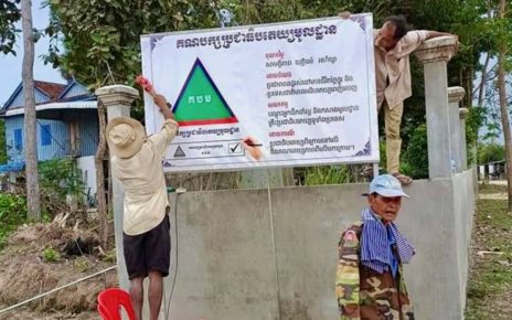 GDP members put up a party sign in Svay Rieng's Svay Yea commune on February 13, 2022. (GDP's Facebook page)