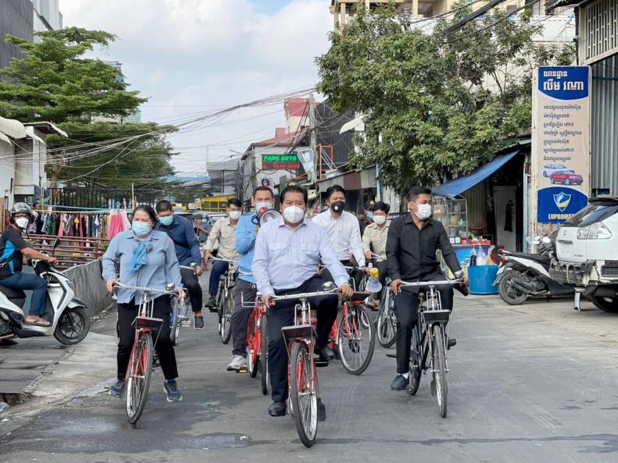Boeng Keng Kang district officials riding bicycles while asking residents to get booster shots to curb the spread of the Omicron variant, as seen in a photo posted on the district's Facebook page on February 21, 2022.