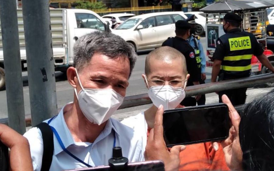 Defense lawyer Choung Chou Ngy and defendant Seng Chan Theary speak outside the Phnom Penh Municipal Court on March 15, 2022. (Ouch Sony/VOD)