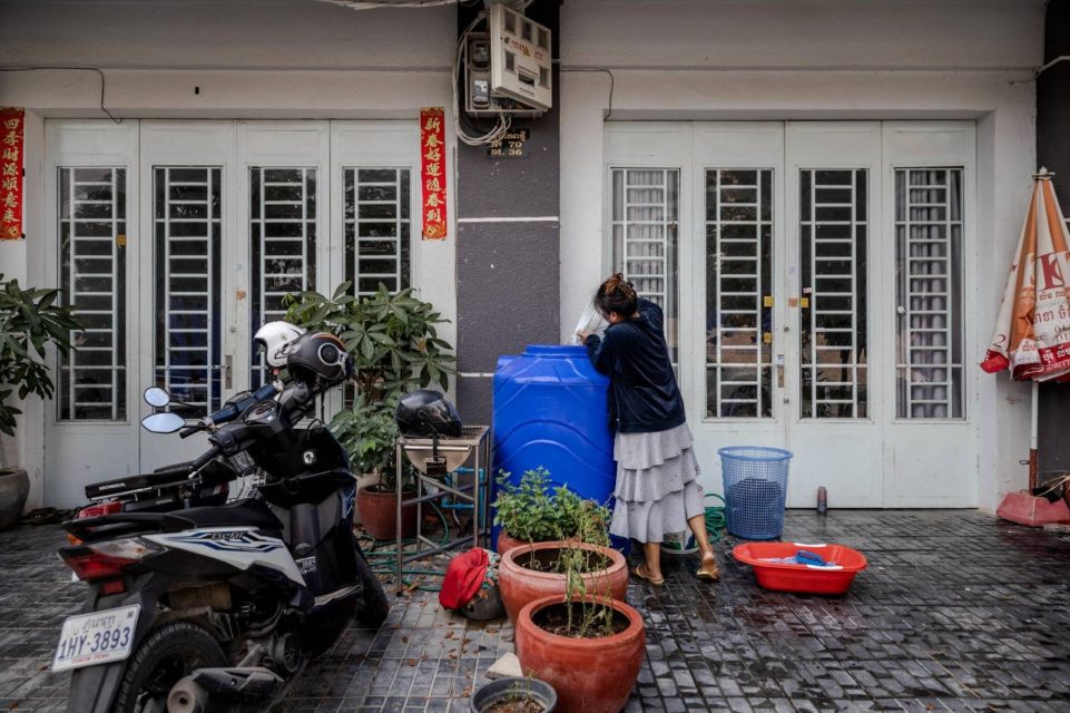 A woman fills a residential water tank in Borey Piphup Thmey on March 22, 2022. (Roun Ry/VOD)