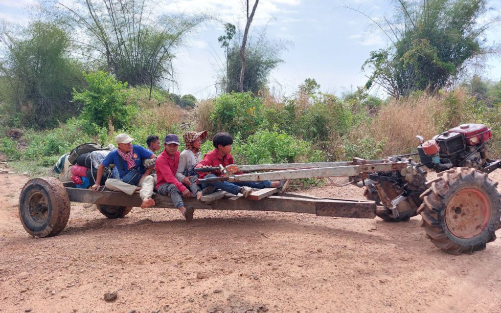 A small group of people in Kratie's Kampong Kbeoung community forest ride a tractor in February 2022. (Keat Soriththeavy/VOD)