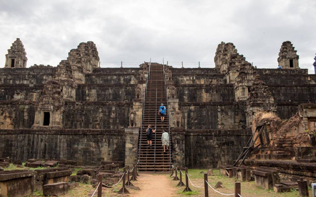 Three visitors, including foreigners, climb stairs near Angkor Wat temple in Siem Reap province on March 31, 2022. (Roun Ry/VOD)