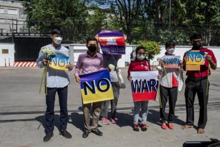 Activists from Mother Nature, Khmer Thavrak and KSILA hold signs in front of the Russian Embassy after attempting to deliver an anti-war petition on April 5, 2022. (Roun Ry/VOD)