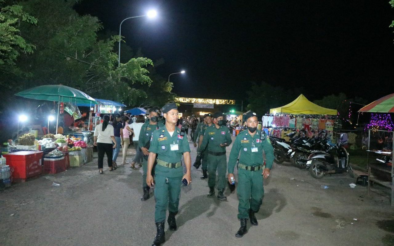 Oddar Meanchey police walk through a street market during Khmer New Year festivities in Samraong city in a photo posted to Facebook on April 15, 2022. (Oddar Meanchey Provincial Police)