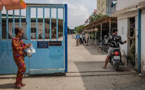 A man drives a motorbike into the gate of Canteran Factory in Phnom Penh's Pur Senchey district after a protest disbanded on the morning of April 19, 2022. (Roun Ry/VOD)