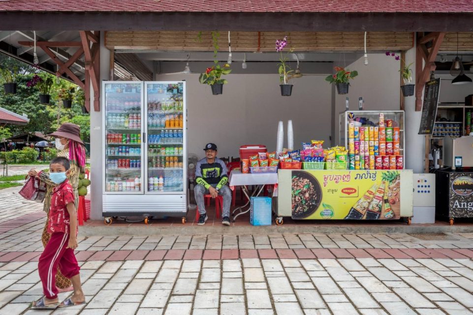 Ket Sarith sits amid his drink and snack stall within the new retail center at Angkor Archaeological Park on April 1, 2022. (Roun Ry/VOD)