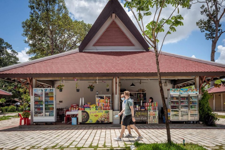 Two tourists walk past a vendor stall in the new retail center in front of Siem Reap's Angkor Wat on April 1, 2022. (Roun Ry/VOD)