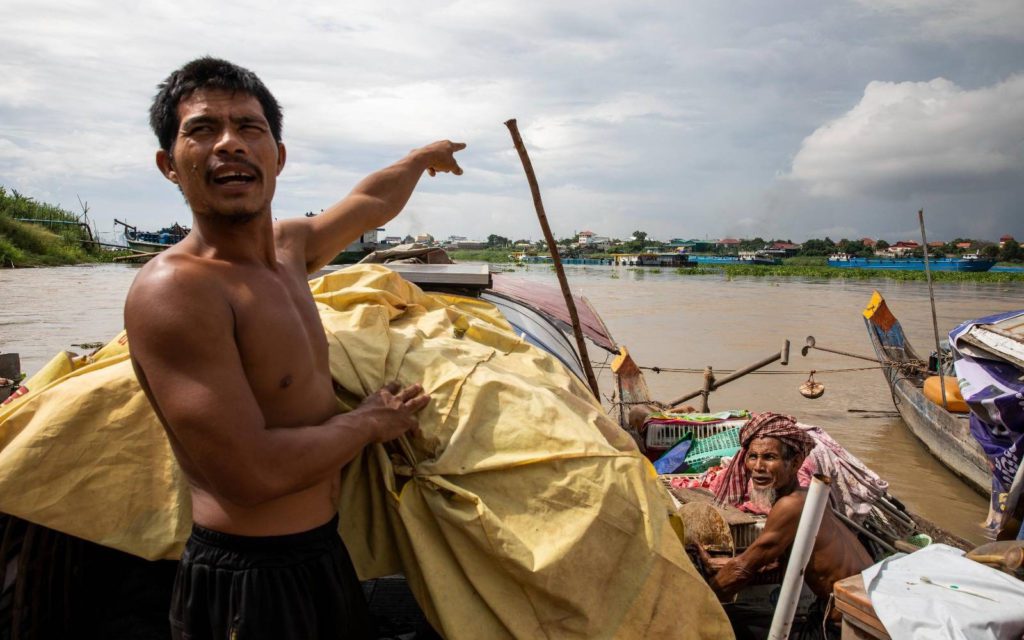 Kao Les points at a sand barge on the Tonle Bassac river May 10, 2022. (Roun Ry/VOD)