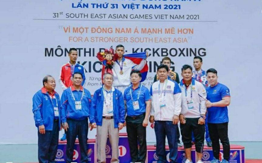 Touch Rachhan wears his gold medal for kickboxing in a photo with the Cambodian delegation for the Southeast Asia Games in Vietnam on May 15, 2022. (Supplied)