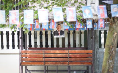 A house in Prek Sleng commune, in Kandal province’s Kandal Stung district, displays ruling party flags and a photo of Prime Minister Hun Sen, on May 6, 2022. (Michael Dickison/VOD)