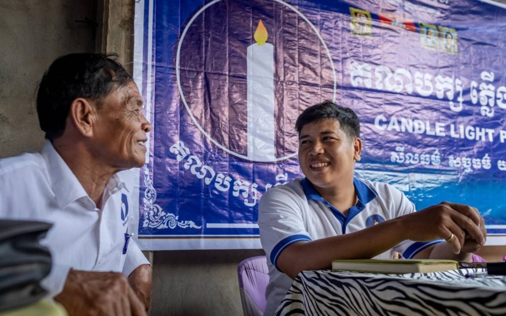 Raiya shares a laugh with a Candlelight colleague in Sdao commune on May 8, 2022.