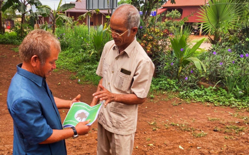 Indigenous People’s Party president Plang Sin speaks to a resident in Mondulkiri on May 15, 2022. (Ananth Baliga/VOD)