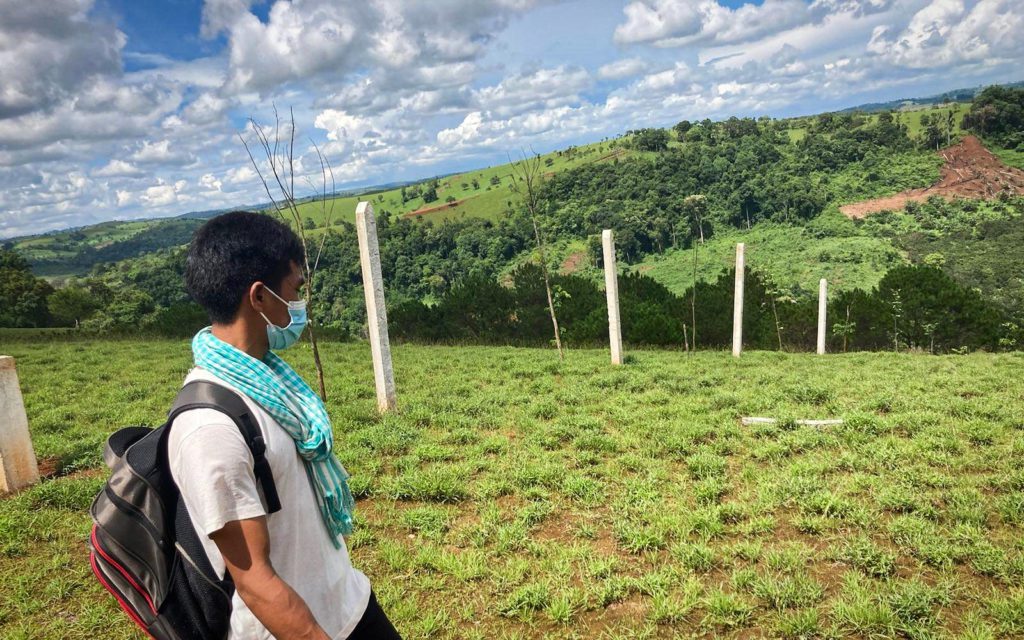 Tay Blong walks near boundary posts on the hills of Mondulkiri’s O’Reang district, in May 2022. (Ananth Baliga/VOD)