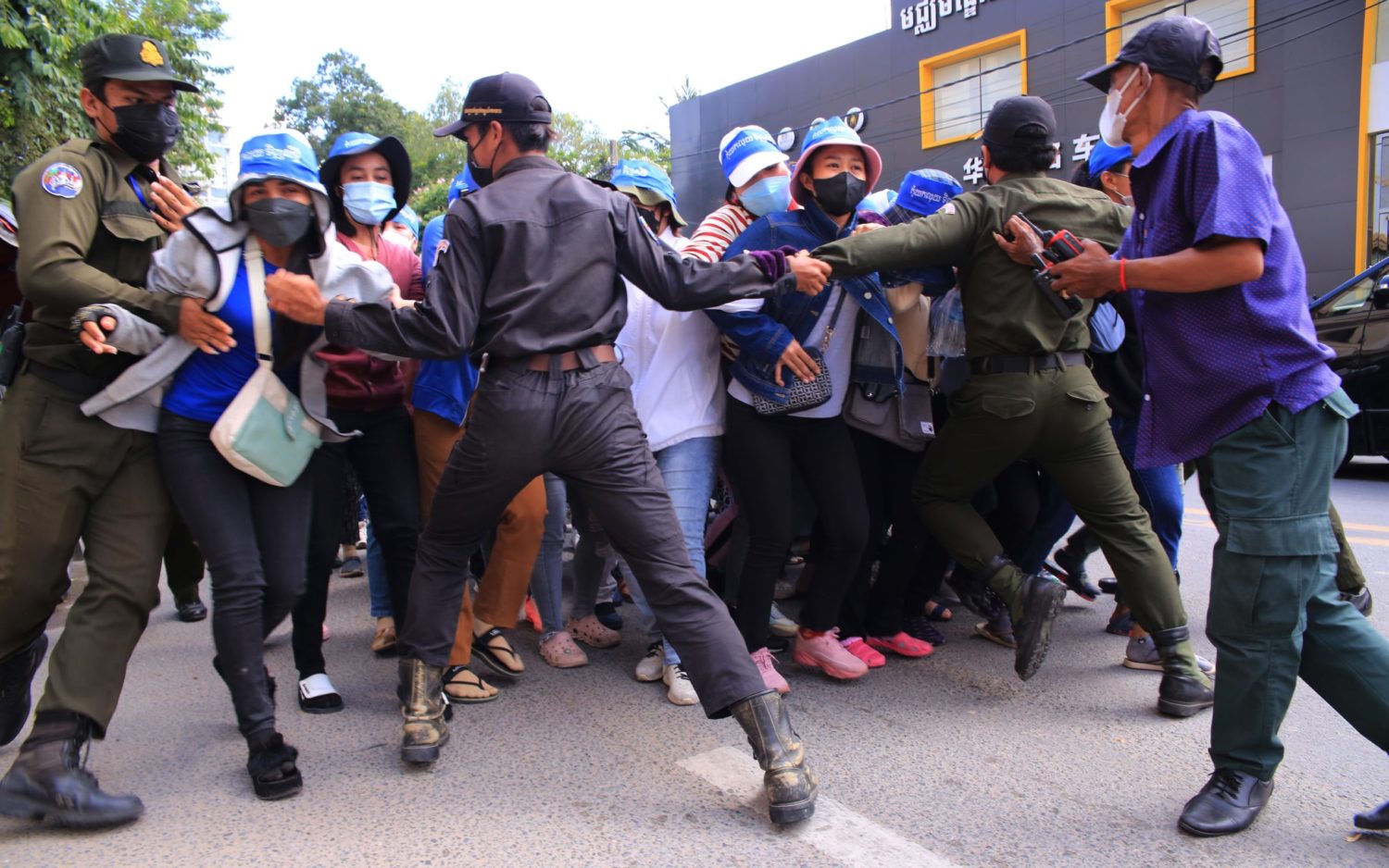 Police officers block NagaWorld protestors at Sothearos Boulevard on June 27, 2022.