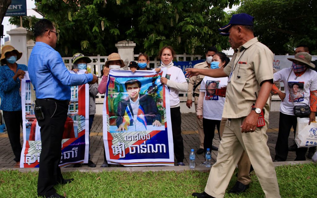 Friday Women protestors hold banners with images of jailed dissidents Ear Channa and Seng Theary on July 1, 2022.