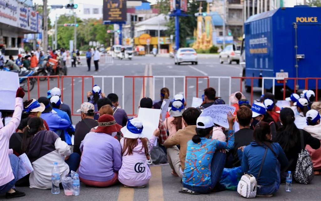 NagaWorld workers are blocked by police barricades on July 5, 2022. 