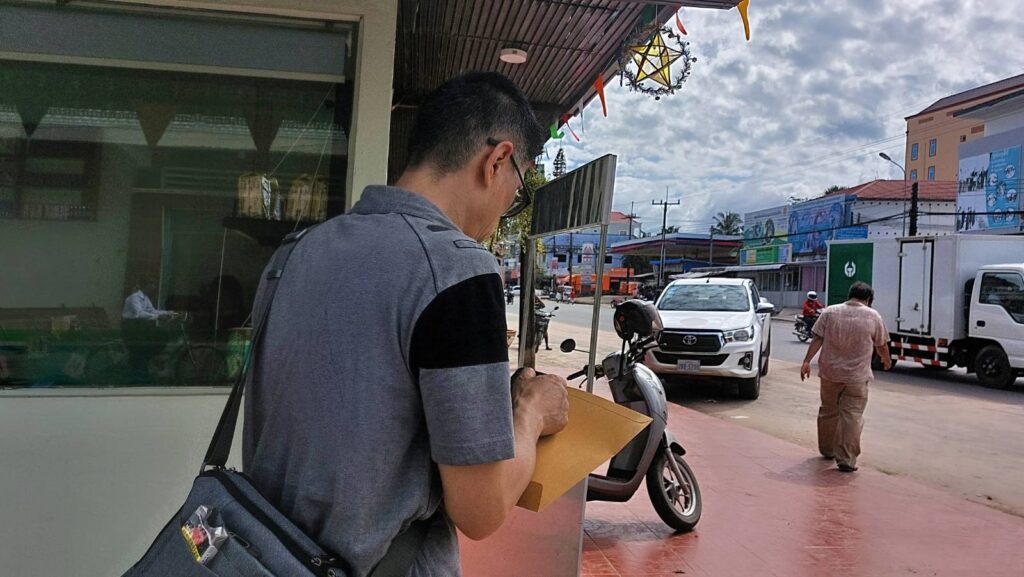 Alex carries a letter from a Taiwanese government office to bring to Koh Kong provincial police in Koh Kong's Khemara Phoumin city on June 10, 2022. (Danielle Keeton-Olsen/VOD)