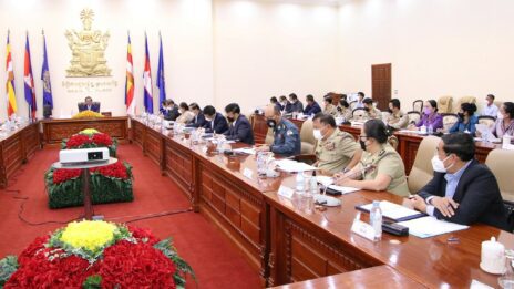 Interior Minister Sar Kheng presents a national action plan against human trafficking, spurred by the U.S.'s decision to lower Cambodia's ranking on human trafficking risk, to multiple ministries and agencies, in a photo posted to Kheng's Facebook on August 9, 2022.