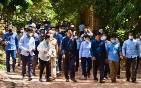 Land Minister Chea Sophara walks with officials through the Angkor area inspecting homes on Thursday. (Chea Sophara's Facebook)