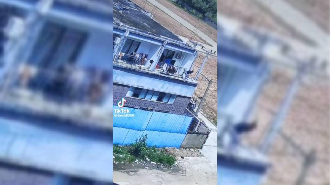 A screenshot from a TikTok video showing a man preparing to jump from a building in Bavet city.