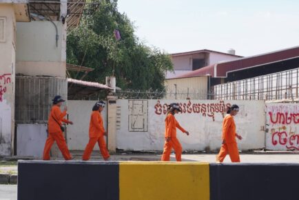 Khmer Thavrak members dressed in orange prison-style jumpsuits march near Freedom Park during their hunger strike during the Asean Summit on November 9, 2022. (Kay Nara/VOD)