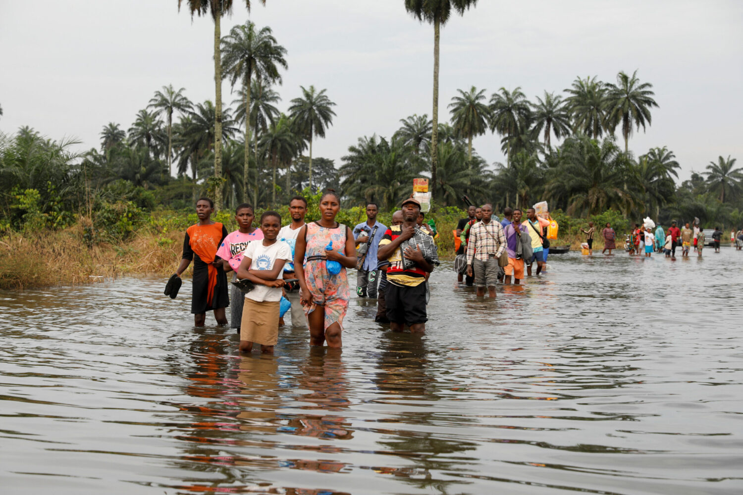 Residents wade through flood water in Obagi community, Rivers state, Nigeria October 21, 2022. (Temilade Adelaja/Reuters)