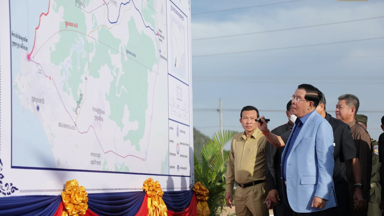 Prime Minister Hun Sen ponders a map of Preah Sihanouk province during the inauguration of a new road, in a photo posted to his Facebook page on December 22, 2022.