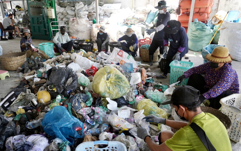 Workers sift through the trash and segregate it for recycling. (Hean Rangsey/VOD)