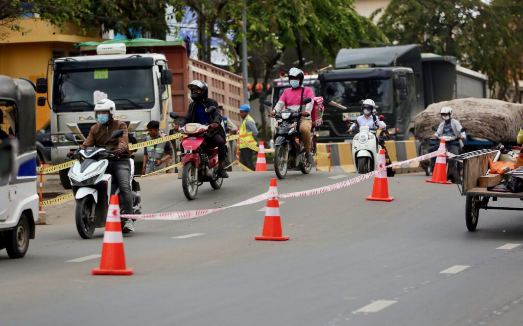 Motorcycles ride over the hump in Phnom Penh's Chak Angre Krom. (Hean Rangsey/VOD)